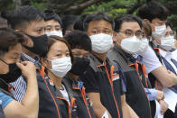 Financial union members wearing face masks to help protect against the spread of the new coronavirus attend a rally against government's financial policy in front of the Financial Supervisory Service in Seoul, Monday, June 29, 2020. (AP Photo/Ahn Young-joon)