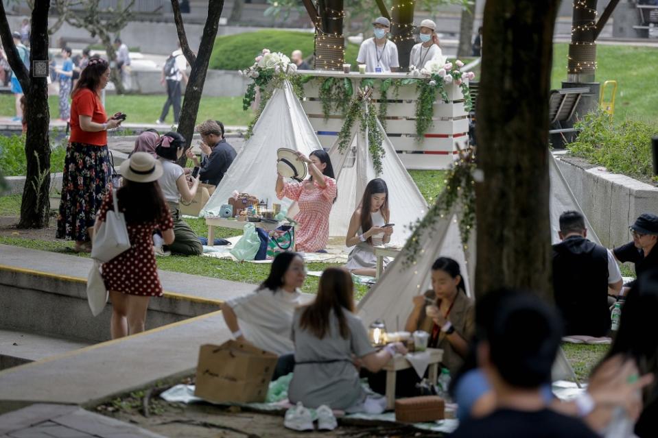 Enjoy an enchanting evening while chilling out at the park with teepee tents and picnic tables adorned with floral arrangements and lights. — Picture by Sayuti Zainudin