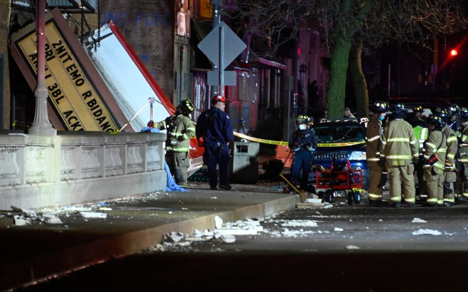 Authorities work the scene at the Apollo Theatre - AP