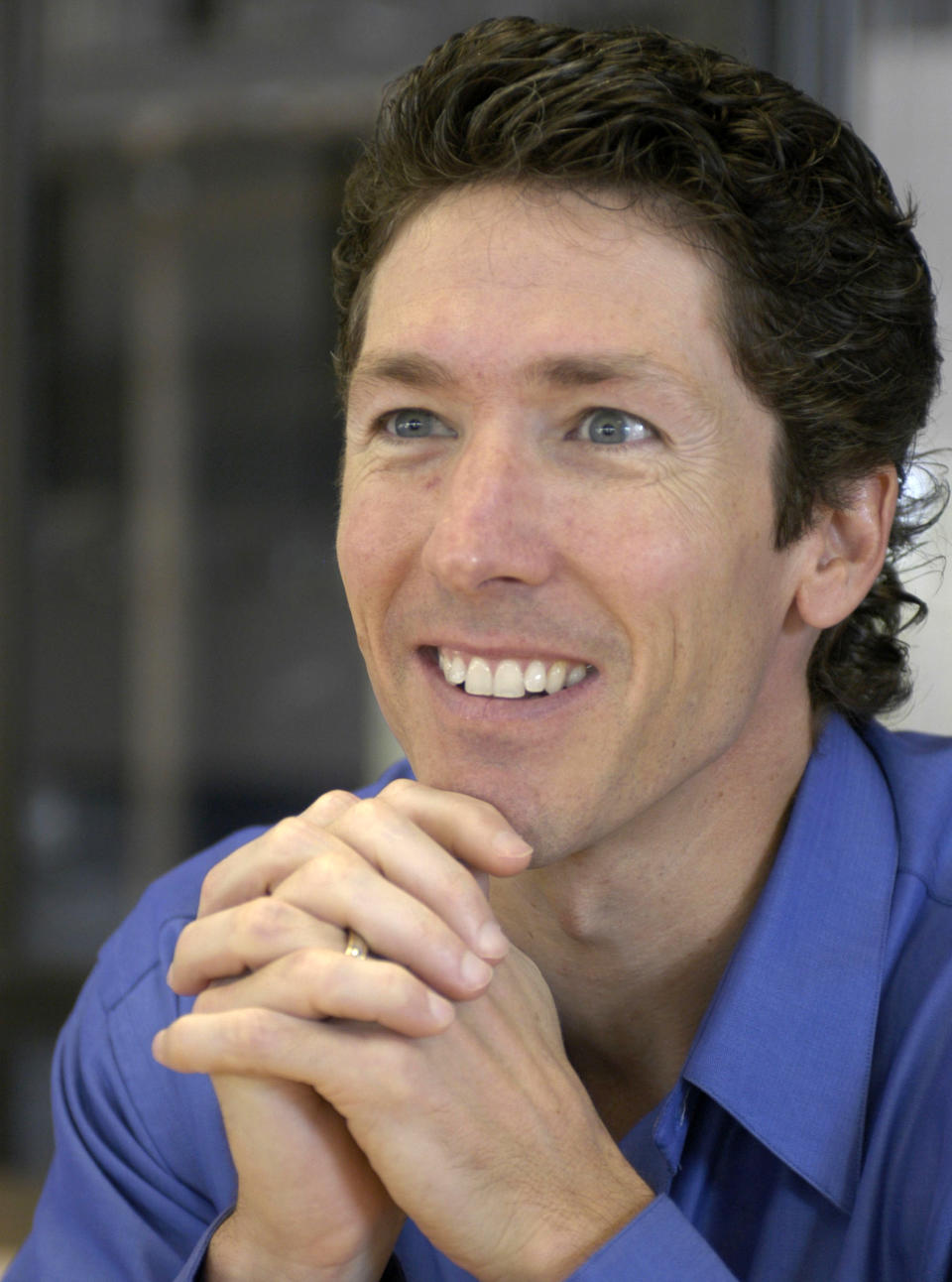 FILE - Lakewood Church pastor Joel Osteen smiles during an interview in the former basketball arena that has become the new home for the church in Houston, in this Sept. 20, 2004, file photo. Authorities are investigating after $600,000 in checks and cash was stolen from a safe at Pastor Joel Osteen's Houston megachurch, which has one of the largest congregations in the country. Police spokesman Kese Smith said Tuesday March 11, 2014 $200,000 in cash and $400,000 in checks were stolen from a safe sometime between 2:30 p.m. Sunday and 8:30 a.m. Monday. (AP Photo/Pat Sullivan)