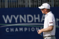 Tom Hoge walks across the 18th green after finishing his opening round of the Wyndham Championship golf tournament at Sedgefield Country Club on Thursday, Aug. 13, 2020, in Greensboro, N.C. (AP Photo/Chris Carlson)