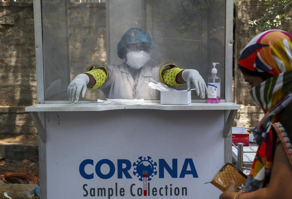 An Indian health worker takes a break between collecting swab samples for COVID-19 test in Hyderabad, India, Monday, May 3, 2021. (AP Photo/Mahesh Kumar A.)