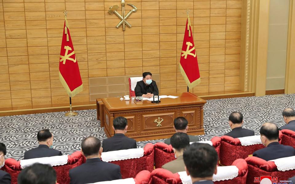 Kim Jong Un, top, attends a meeting on anti-virus strategies in Pyongyang