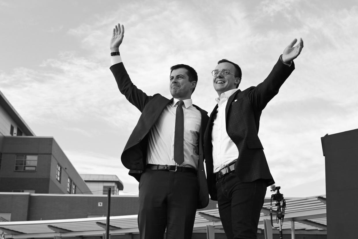 Pete Buttigieg, then a Democratic presidential candidate, and his husband, Chasten Buttigieg, wave to the crowd at a campaign event in 2020.