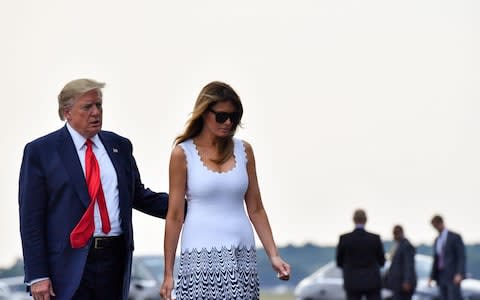 Photo of US President Donald Trump with his wife Melania, talking towards Air Force One in Bordeaux - Credit: Nicholas Kamm/AFP