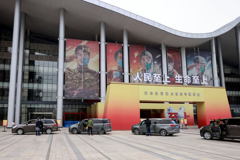 WHO team members visit an exhibition on how China fought the coronavirus in Wuhan