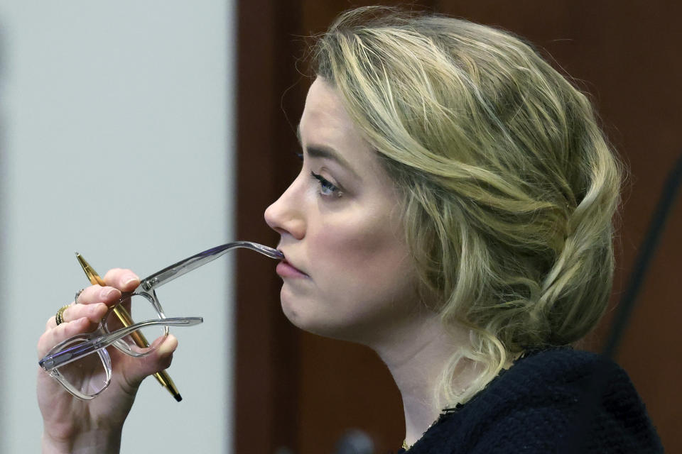 Actor Amber Heard listens in the courtroom at the Fairfax County Circuit Court in Fairfax, Va., Thursday, April 28, 2022. Actor Johnny Depp sued his ex-wife actor Amber Heard for libel in Fairfax County Circuit Court after she wrote an op-ed piece in The Washington Post in 2018 referring to herself as a "public figure representing domestic abuse." (Michael Reynolds/Pool Photo via AP)