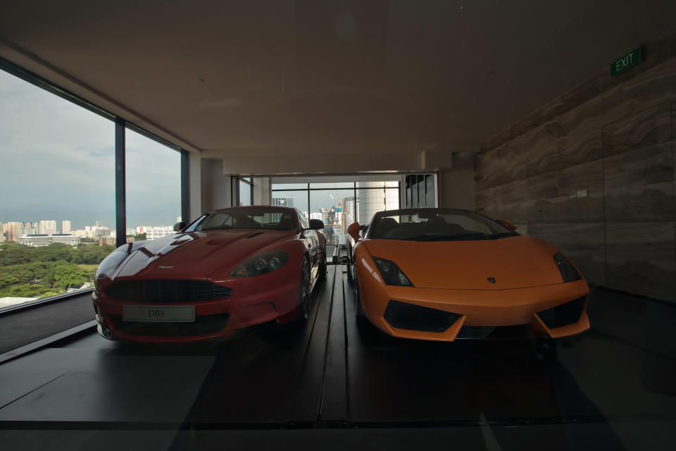 A Lamborghini Gallardo (R) arrives at an ensuite elevated garage on a 14th floor luxury apartment at the Hamilton Scotts luxury residence in Singapore August 23, 2012. Starting at S$9.5 million ($7.5 million) for the basic floor plan, each residence has two ensuite parking spaces, according to the property developer. (Yahoo! photo)