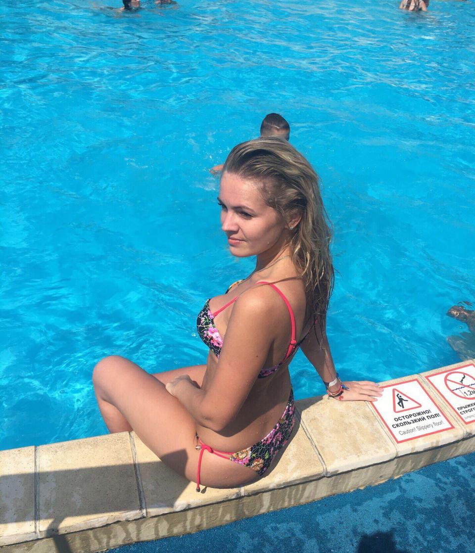 Evgenia Shulyatyeva poses for a photo next to a swimming pool. Her mother found her dead after she failed to answer her phone.