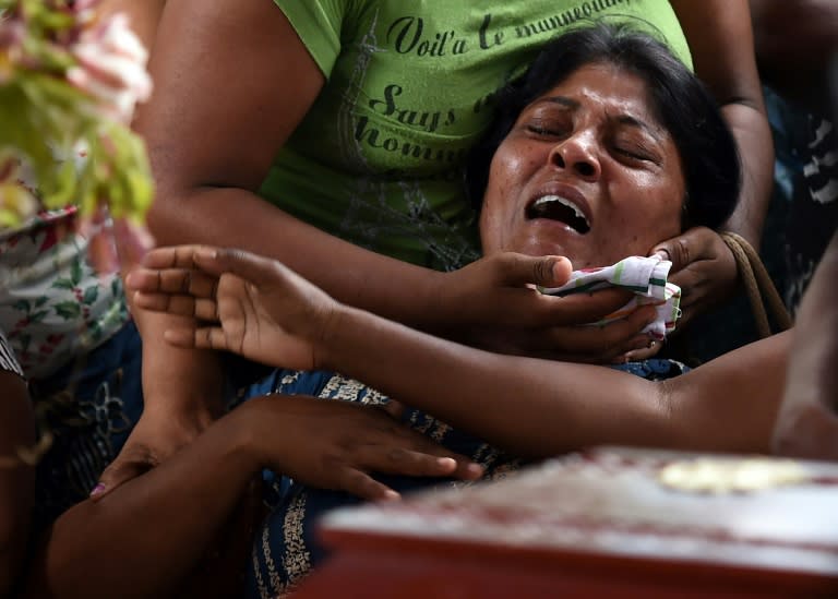A Sri Lankan woman grieves at the coffin of her daughter who died when a garbage dump collapsed in Colombo