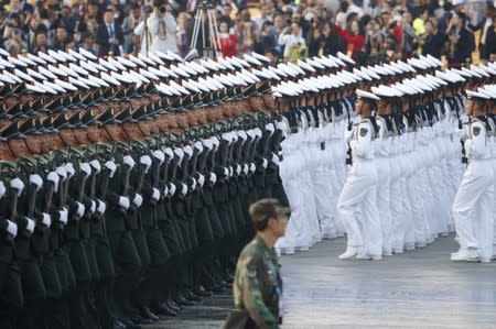 Soldiers of PLA march in formation past Tiananmen Square before a military parade marking the 70th founding anniversary of People's Republic of China