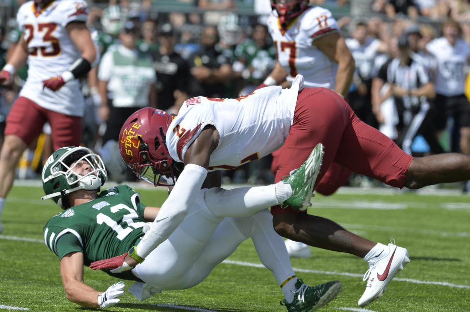 Sep 16, 2023; Athens, Ohio, USA; Ohio Bobcats wide receiver Sam Wiglusz (12) takes a hit from Iowa State Cyclones defensive back T.J. Tampa (2) during the second quarter at Peden Stadium. Mandatory Credit: Matt Lunsford-USA TODAY Sports