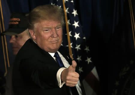 Republican U.S. presidential candidate Donald Trump reacts at his 2016 New Hampshire presidential primary night rally in Manchester, New Hampshire February 9, 2016. REUTERS/Mike Segar