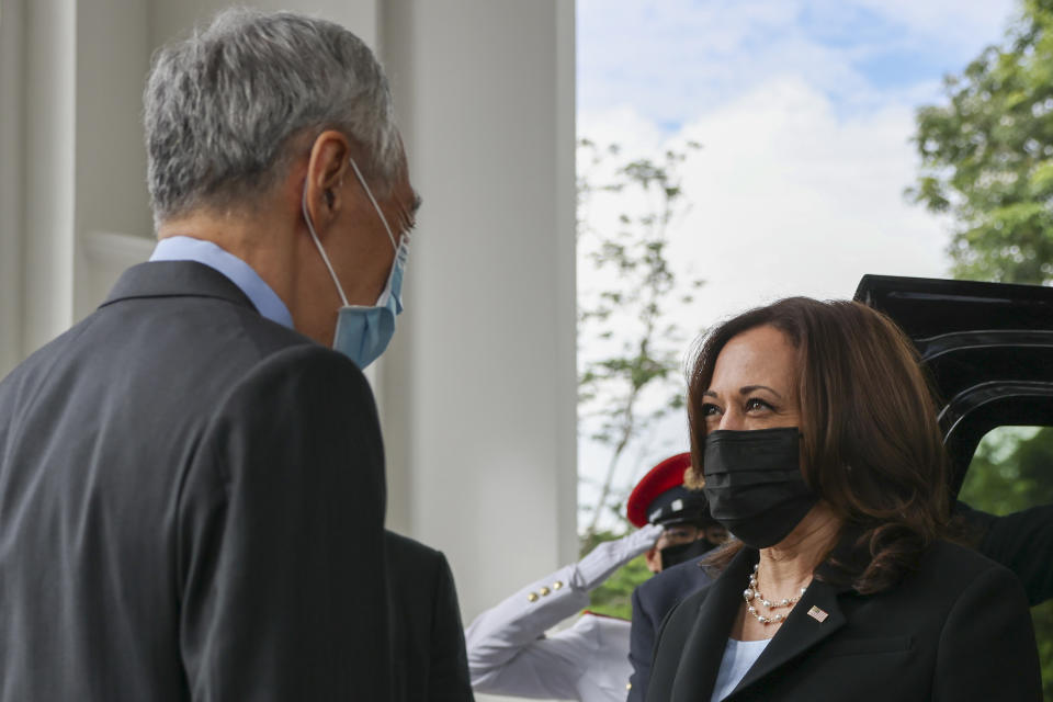 U.S. Vice President Kamala Harris, right, is welcomed by Singapore's Prime Minister Lee Hsien Loong at the Istana in Singapore Monday, Aug. 23, 2021. (Evelyn Hockstein/Pool Photo via AP)