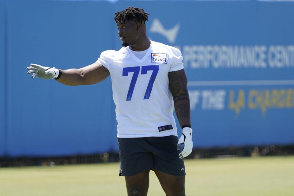 Chargers offensive lineman Zion Johnson makes an inquiry during camp.