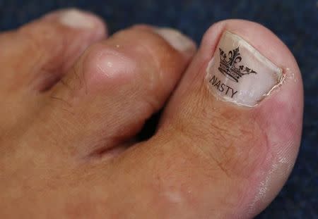 The toe of Alan "Nasty" Nash is seen, as he waits to compete in the World Toe Wrestling championships in Ashbourne, central England June 8, 2013. REUTERS/Darren Staples