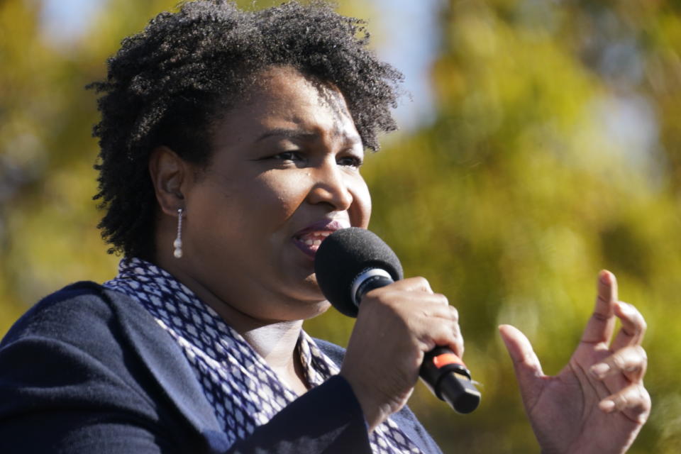 FILE - In this Nov. 2, 2020, file photo Stacey Abrams speaks to Biden supporters as they wait for former President Barack Obama to arrive and speak at a rally as he campaigns for Democratic presidential candidate former Vice President Joe Biden at Turner Field in Atlanta. Abrams, Georgia's well-known voting rights advocate, is taking a carefully balanced approach in response to new laws many people have said are an attempt to suppress votes of people of color. When asked about the law changes, she is critical but measured. (AP Photo/Brynn Anderson, File)