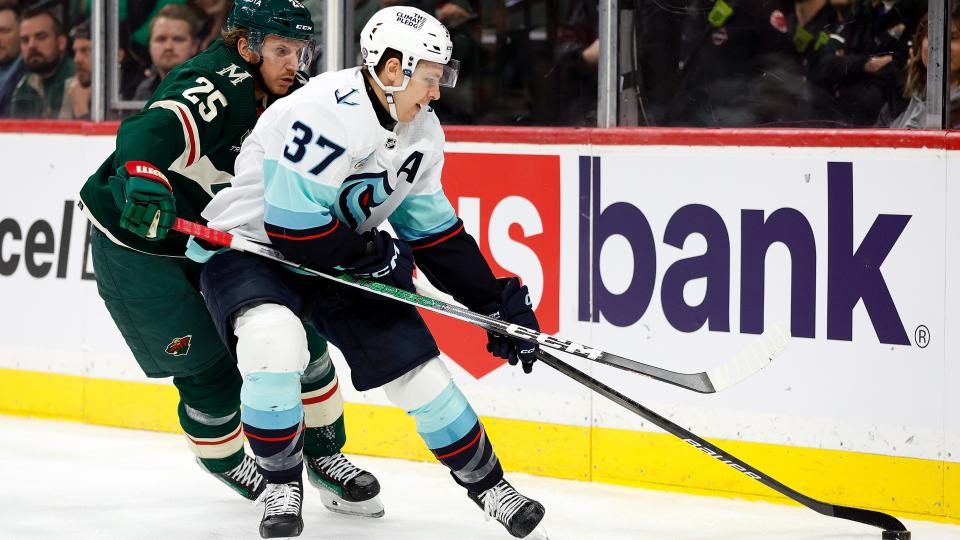  Anni Gourde #37 of the Seattle Kraken skates with the puck against Jonas Brodin #25 of the Minnesota Wild in the first period at Xcel Energy Center on April 18, 2024. 