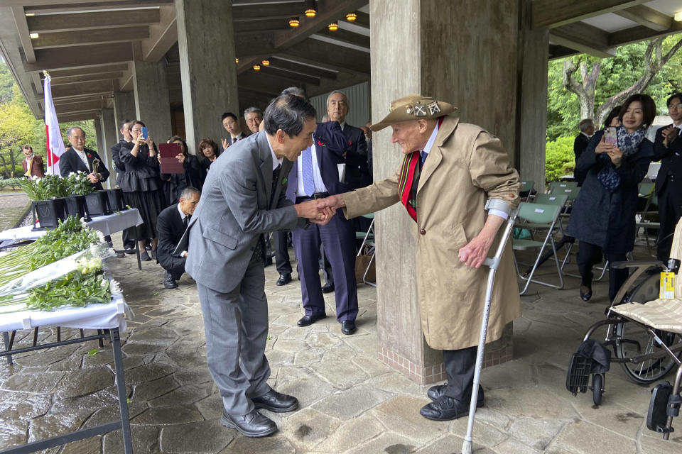 Richard Day, 97, right, a British army veteran who survived the Burma Campaign, one of the harshest battles in the World War II, shakes hands with Yukihiro Torikai, left, a Tokai University humanities professor whose late grandfather also fought in the campaign, during a memorial at the Chidorigafuchi National Cemetery in Tokyo, Monday, Oct. 9, 2023. The memorial was attended by military officials from the embassies of several former allied nations, including Australia, Britain, New Zealand and the U.S. at the cemetery for the unknown Japanese who died overseas during the war. (AP Photo/Mari Yamaguchi)