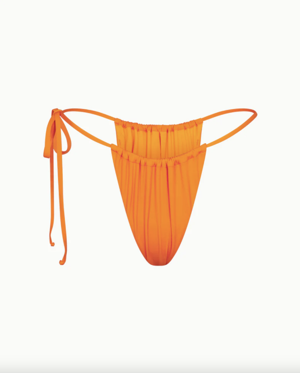 <a href="https://www.khy.com/products/ruched-tie-bikini-bottom-sunset" rel="nofollow noopener" target="_blank" data-ylk="slk:Shop Now;elm:context_link;itc:0;sec:content-canvas" class="link ">Shop Now</a><p>Ruched Tie swimsuit Bottom</p><p>khy.com</p><p>$34.00</p>
