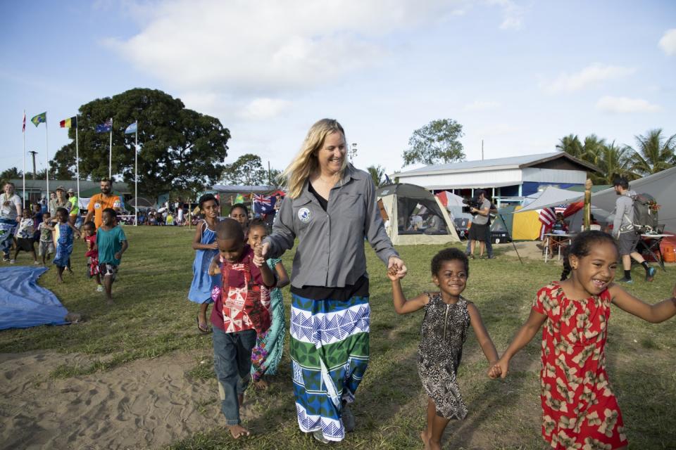 "Eco-Challenge" showrunner Lisa Hennessy gets in some playtime with Fijian locals.