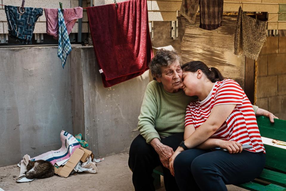 Family spend time outside bomb shelter.