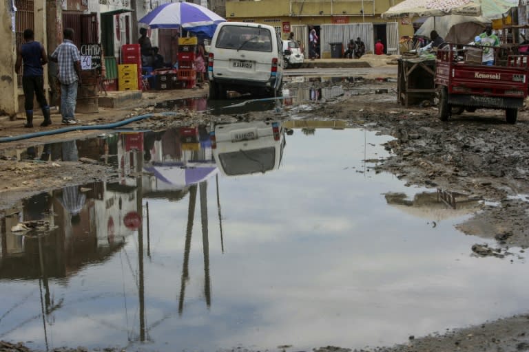 Stagnant water gathers across a road in a Luanda slum -- an ideal breeding ground for mosquitoes