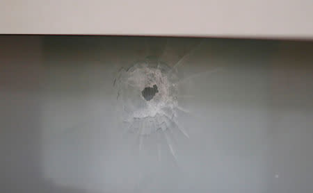 A bullet hole is seen on a window. REUTERS/Mathieu Belanger