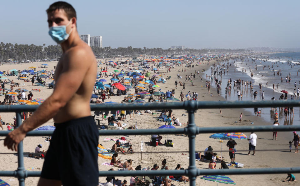 Californians soak up the sun as coronavirus cases hit new global milestone. 