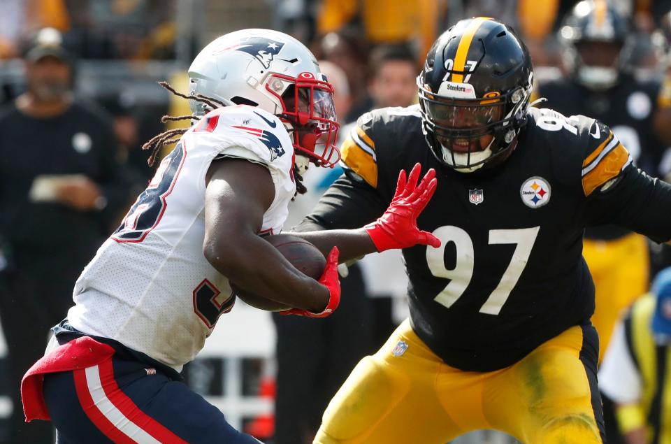 New England Patriots running back Rhamondre Stevenson (38) runs the ball against Pittsburgh Steelers defensive tackle Cameron Heyward.