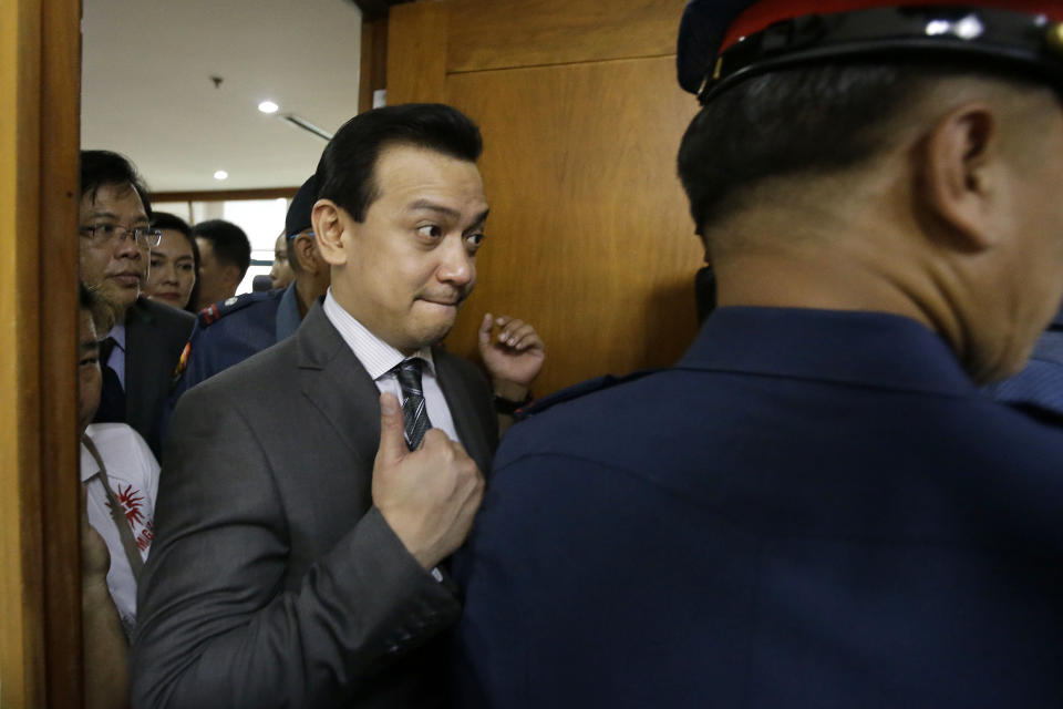 Philippine opposition Sen. Antonio Trillanes IV flashes a thumbs-up sign as he leaves the Makati Regional Trial Court Branch 150 after it has issued an order for his arrest Tuesday, Sept. 25, 2018, in suburban Pasay city, south of Manila, Philippines. Trillanes who remained holed up in his office for three weeks now after President Rodrigo Duterte voided an amnesty given to the former rebel military officer, willingly went with police to post bail. (AP Photo/Aaron Favila)