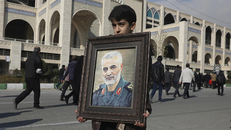 A boy carries a portrait of Iranian Revolutionary Guard Gen. Qassem Soleimani, who was killed in the U.S. airstrike in Iraq, prior to the Friday prayers in Tehran, Iran, Friday Jan. 3, 2020. (Photo: Vahid Salemi/AP)