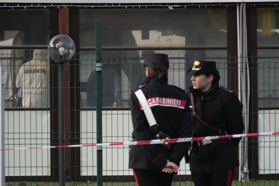 Italian Carabinieri patrol in front of a bar where three people died after a man entered and shot in Rome, Sunday, Dec. 11, 2022. (AP Photo/Gregorio Borgia)