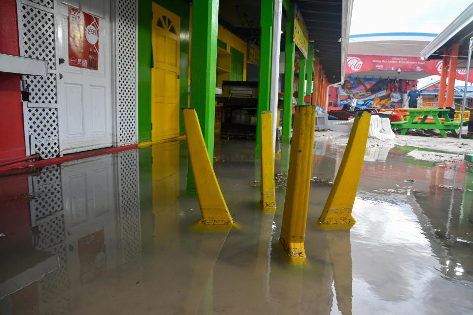 Damaged outdoor furniture is seen in a flooded area after the passage of Hurricane Beryl in Oistins gardens, Christ Church, Barbados (AFP via Getty Images)