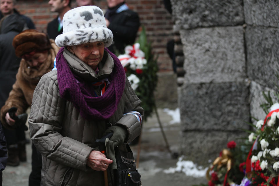 A member of an association of Auschwitz survivors stands at the execution wall during a wreath-laying ceremony at the former Auschwitz I concentration camp on January 27, 2015 in Oswiecim, Poland. International heads of state, dignitaries and over 300 Auschwitz survivors are attending the commemorations for the 70th anniversary of the liberation of Auschwitz by Soviet troops on 27th January, 1945. Auschwitz was among the most notorious of the concentration camps run by the Nazis during WWII and whilst it is impossible to put an exact figure on the death toll it is alleged that over a million people lost their lives in the camp, the majority of whom were Jewish.