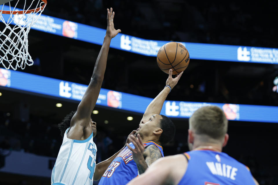 Oct 15, 2023; Charlotte, North Carolina, USA; Oklahoma City Thunder guard Tre Mann (23) shoots against Charlotte Hornets guard Frank Ntilikina in the first half at Spectrum Center. Mandatory Credit: Nell Redmond-USA TODAY Sports