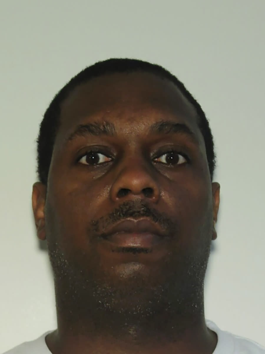 In this undated booking photo provided by the Atlanta Police Department is suspect Kenny Wells. Authorities say a passenger awaiting a bag search at the Atlanta airport's main security checkpoint reached into the bag and grabbed a firearm, and it went off, causing chaos among travelers and prompting a temporary FAA ground stop on flights Saturday afternoon, Nov. 20, 2021, officials said. Police said later Saturday evening that they had identified the passenger as a 42-year-old convicted felon, Wells, and a warrant was issued for his arrest. (Atlanta Police Department via AP)