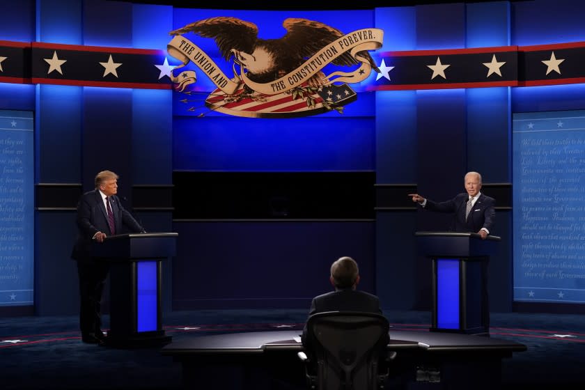 President Donald Trump, left, and Democratic presidential candidate former Vice President Joe Biden, right, during the first presidential debate Tuesday, Sept. 29, 2020, at Case Western University and Cleveland Clinic, in Cleveland, Ohio. Seated in the center is moderator Chris Wallace of Fox News. (AP Photo/Patrick Semansky)