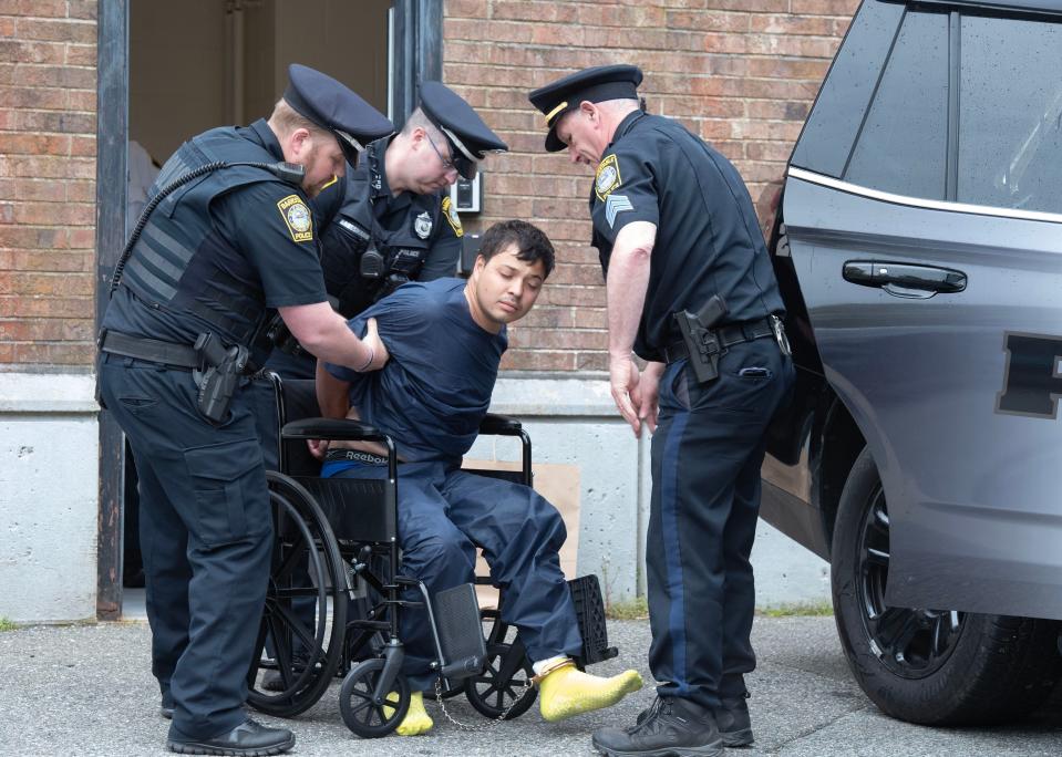 Ygor Barboza, 24, is lifted into a wheelchair Wednesday outside Barnstable District Court in Barnstable Village for his arraignment related to a stabbing Tuesday in Centerville.