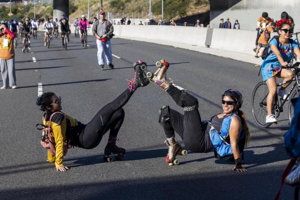 Rollerbladers Jenny Renderos and Veronica Rico pose for a rare photo in the middle of the 110 Freeway.