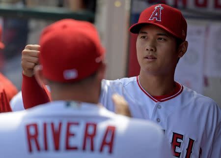 Apr 8, 2018; Anaheim, CA, USA; Los Angeles Angels starting pitcher Shohei Ohtani (17) is greeted by teammates in the dugout against the Oakland Athletics during a MLB baseball game at Angel Stadium of Anaheim. Kirby Lee-USA TODAY Sports