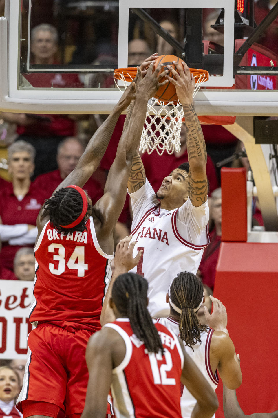 Indiana center Kel'el Ware, top right, and Ohio State center Felix Okpara (34) reach for a rebound during the second half of an NCAA college basketball game Saturday, Jan. 6, 2024, in Bloomington, Ind. (AP Photo/Doug McSchooler)