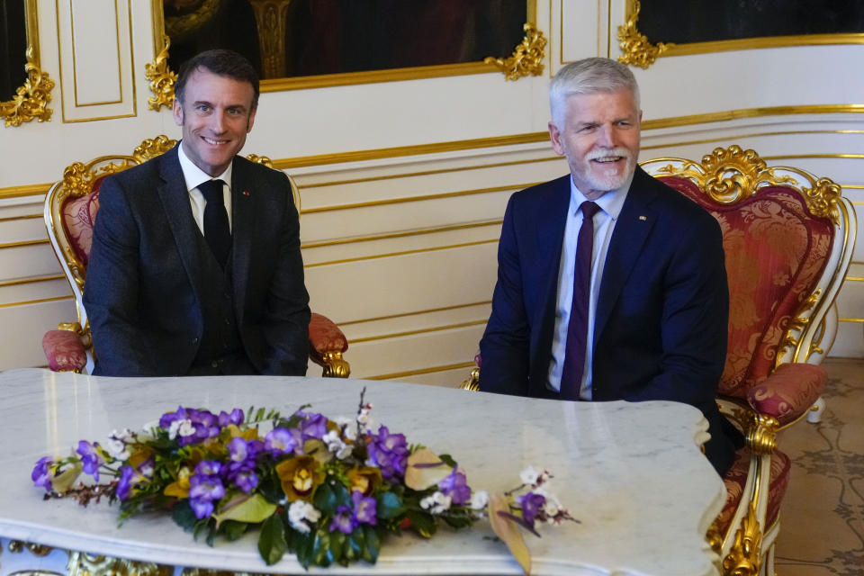 French President Emmanuel Macron, left, smiles during talks with his Czech Republic's counterpart Petr Pavel at the Prague Castle in Prague, Czech Republic, Tuesday, March 5, 2024. Macron is on a one-day official visit to Czech Republic. (AP Photo/Petr David Josek)