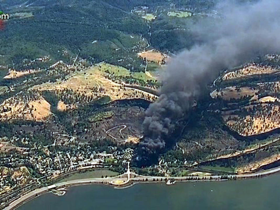 FILE In this June 3, 2016, file image, from video provided by KGW-TV, smoke billows from a Union Pacific train that derailed near Mosier, Ore., in the scenic Columbia River Gorge. The nation's largest railroad has agreed to more thorough inspections and maintenance improvements after the fiery oil train derailment in Oregon and the discovery of more than 800 potential safety violations across its sprawling network. (KGW-TV via AP, File)