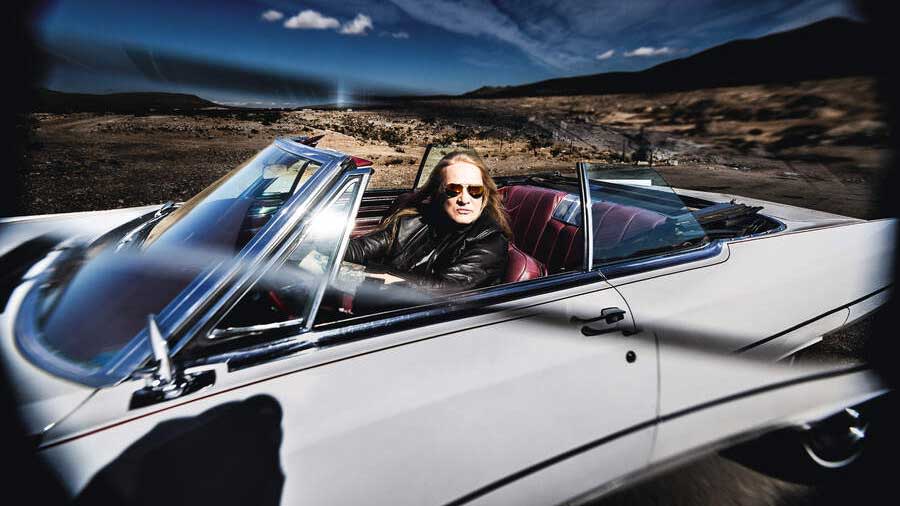  Sebastian Bach in a convertable car in the desert. 