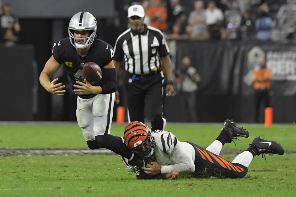 Cincinnati Bengals defensive end Trey Hendrickson (91) forces Las Vegas Raiders quarterback Derek Carr (4) to fumble the ball during the second half of an NFL football game, Sunday, Nov. 21, 2021, in Las Vegas. (AP Photo/David Becker)