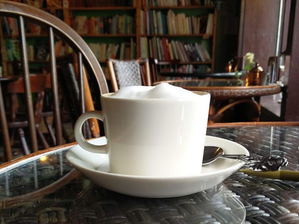 cup of coffee in tokyo cafe with books in the background