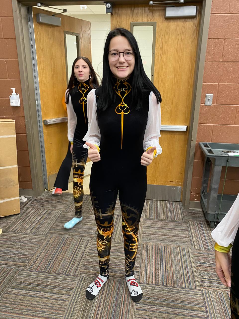 Junior Samara Griffin shows off the new velvet uniform for the Hardin Valley Academy Winter Guard show, “Golden Hour,” set to debut at a WGI Regionals and World Championships in Dayton, Ohio, this season.