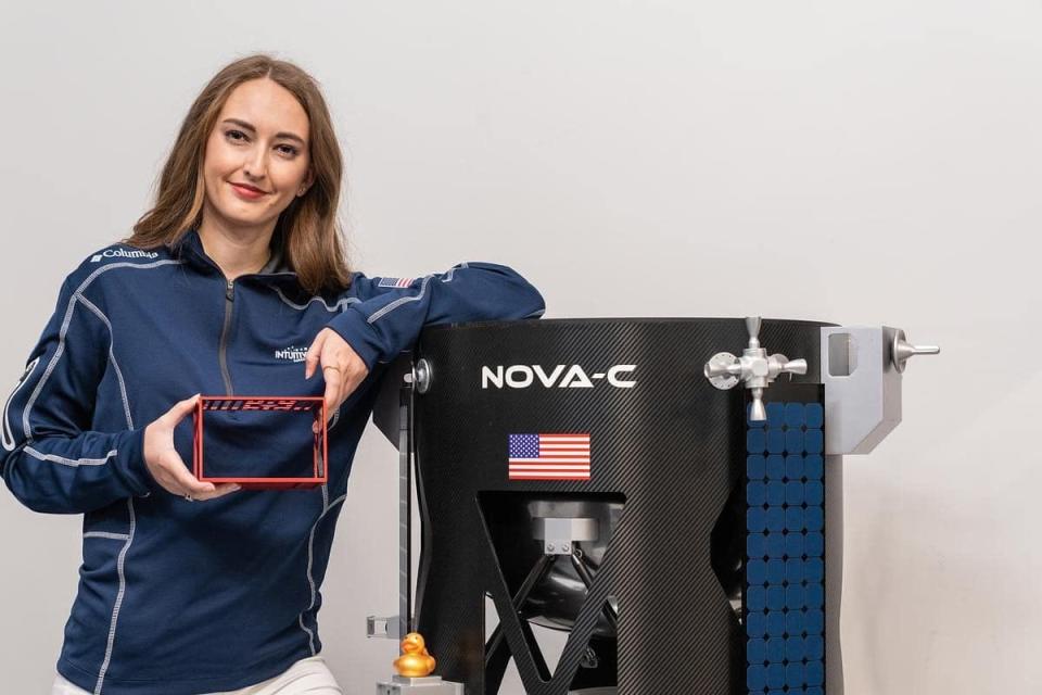 Embry-Riddle Aeronautical University graduate student Taylor Yow poses with the EagleCam, a satellite camera that will be launched to the moon. She was part of a team of ERAU students who developed the camera for Intuitive Machines.