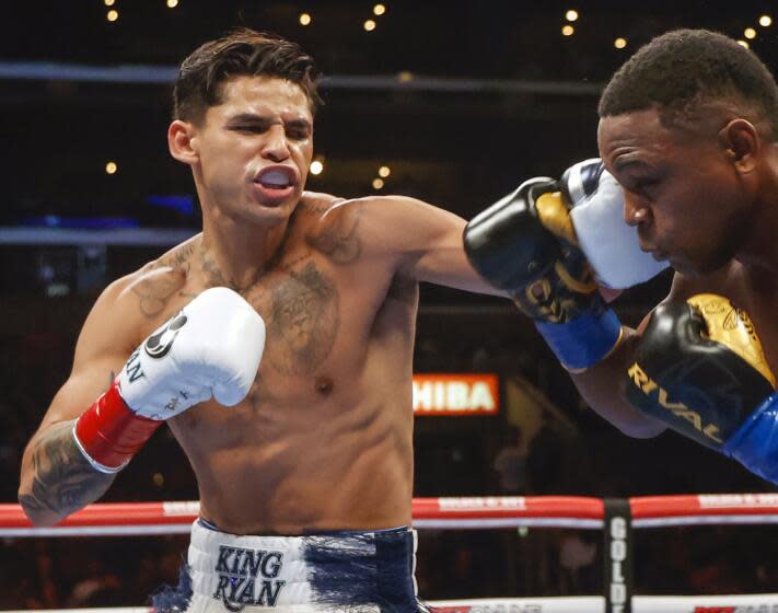 FILE - Ryan Garcia, left, hits Javier Fortuna, right, during a lightweight boxing bout July 16, 2022, in Los Angeles. The fighters seemed just as surprised as fight fans when it was announced that Garcia and Devin Haney, two Californians, would have their April 20, 2024, title fight in New York. But Oscar De La Hoya, Garcia's promoter, says bringing the event to Brooklyn is common sense. (AP Photo/Ringo H.W. Chiu, File)